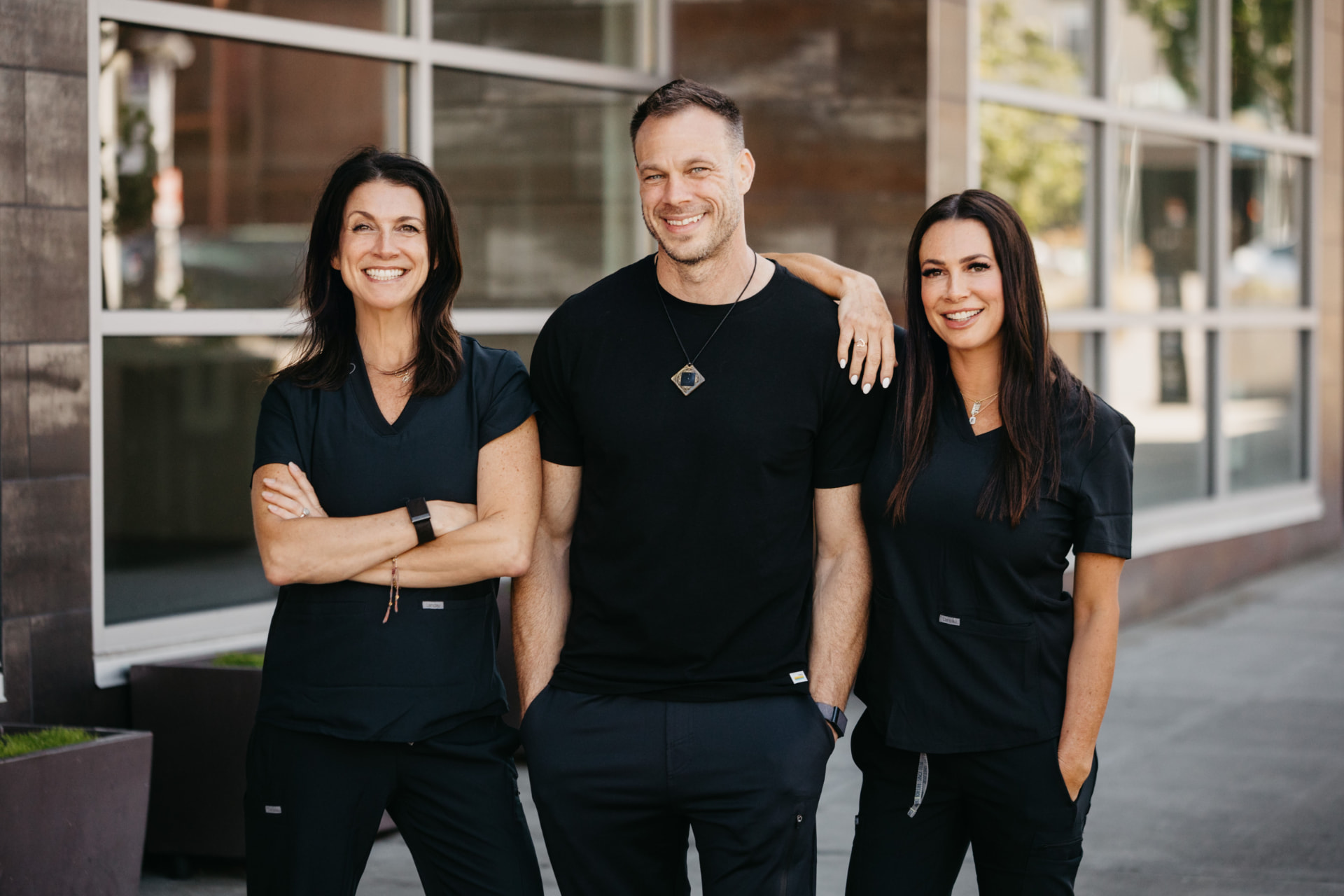 The three sibling founders of Recharge standing outside the club