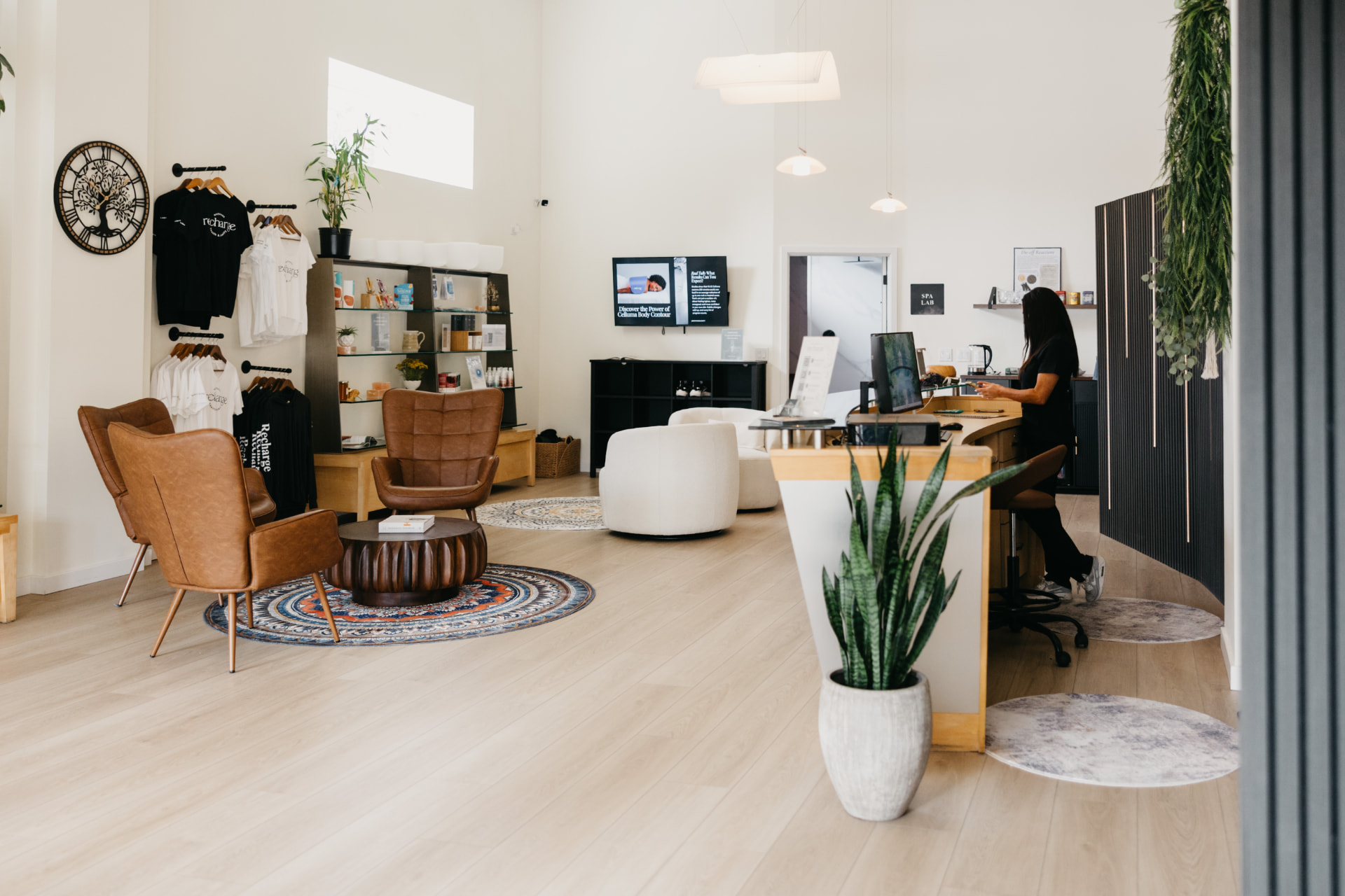 The Recharge lobby with lounge chairs, retail shelves and the front desk
