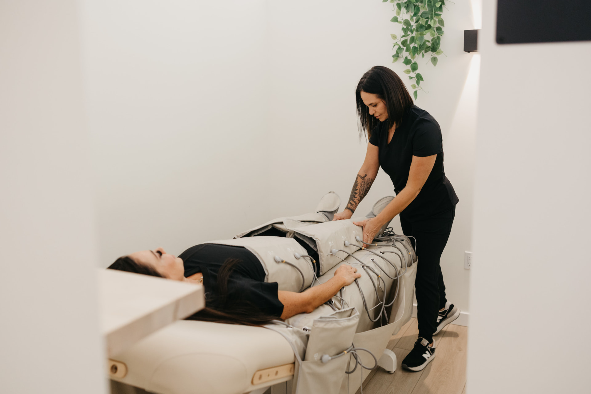 A Recharge team member fitting a member with lymphatic compression wraps