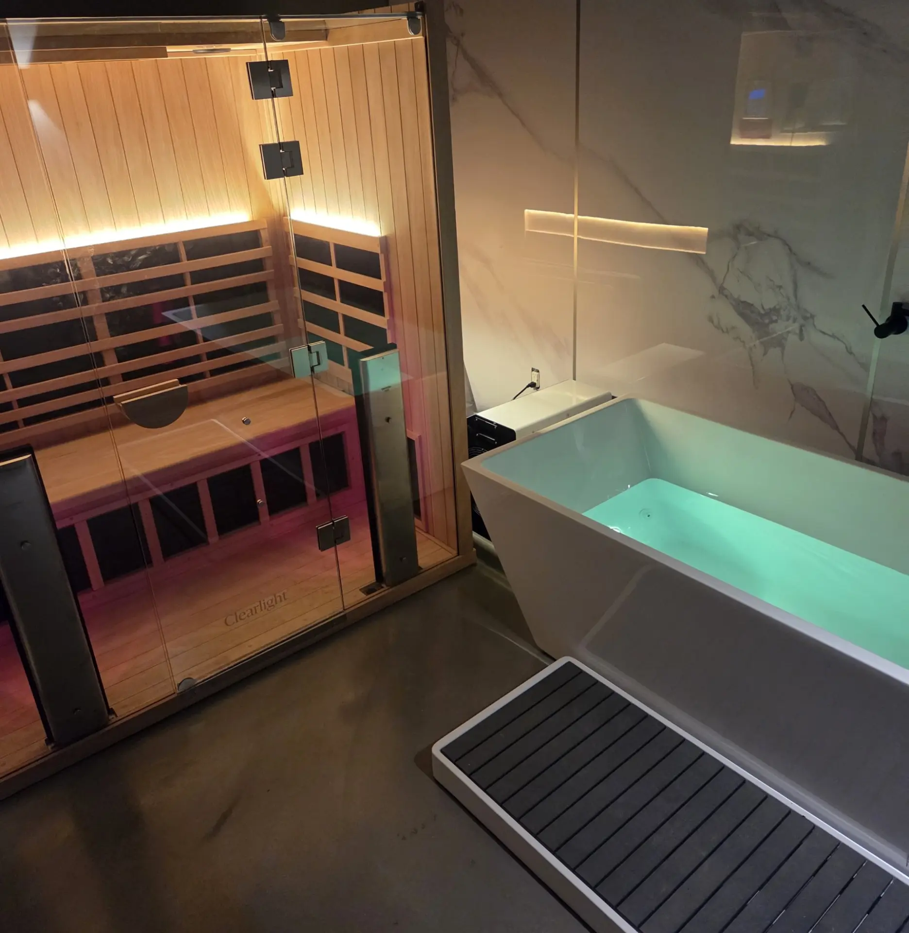 The Recharge contrast therapy room with an infrared sauna next to a cold plunge tub